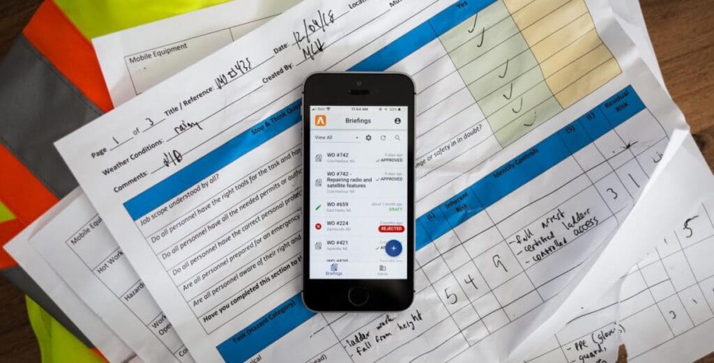 app in phone on paperwork