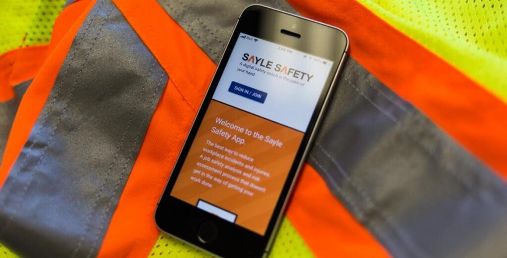 Safety app on phone on construction vest
